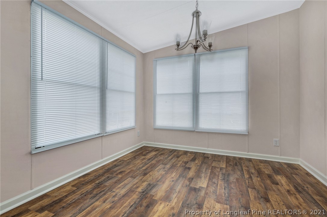 6544 Sandy Creek Road Stedman, NC 28391 - Photo 11 of 32 a view of an empty room with a window and wooden floor