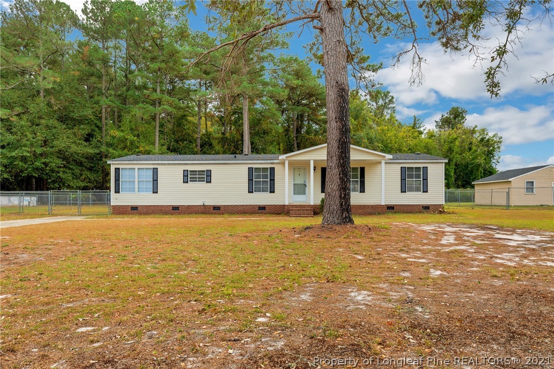 6544 Sandy Creek Road Stedman, NC 28391 - Photo 2 of 32 a front view of house with yard and swimming pool