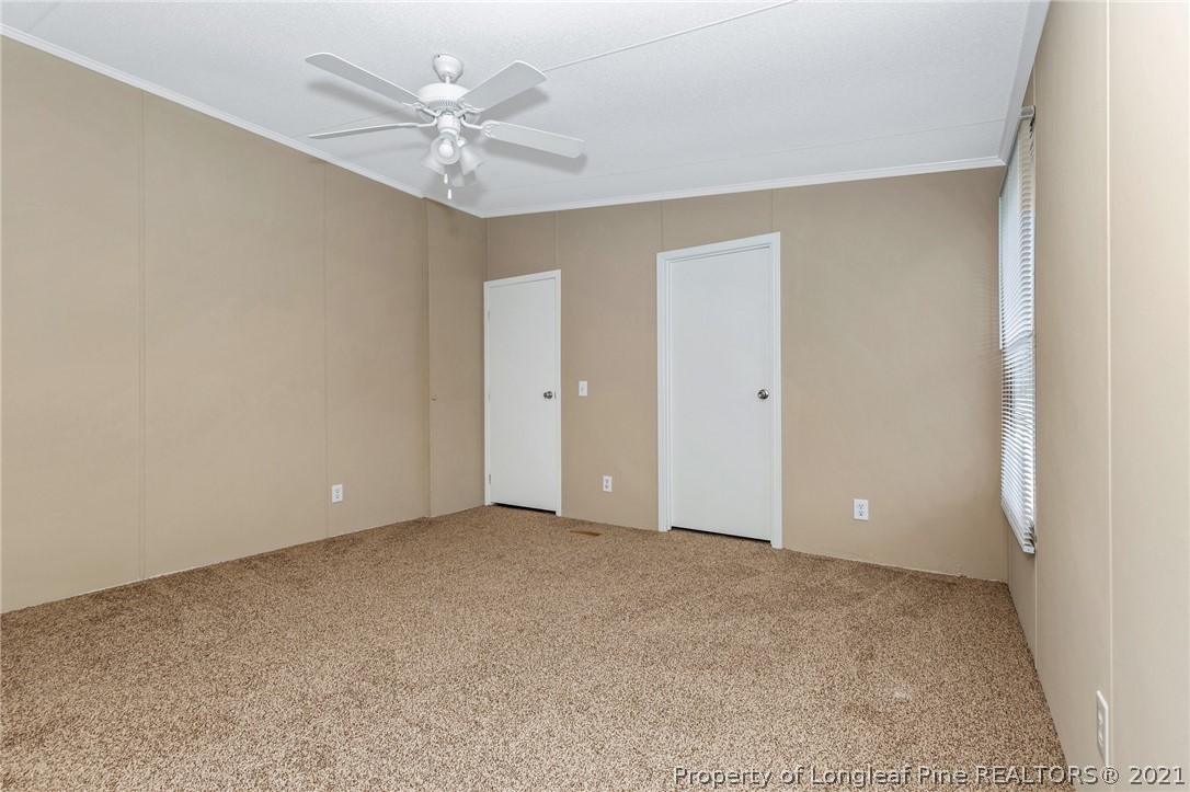 6544 Sandy Creek Road Stedman, NC 28391 - Photo 21 of 32 a view of an empty room with a ceiling fan