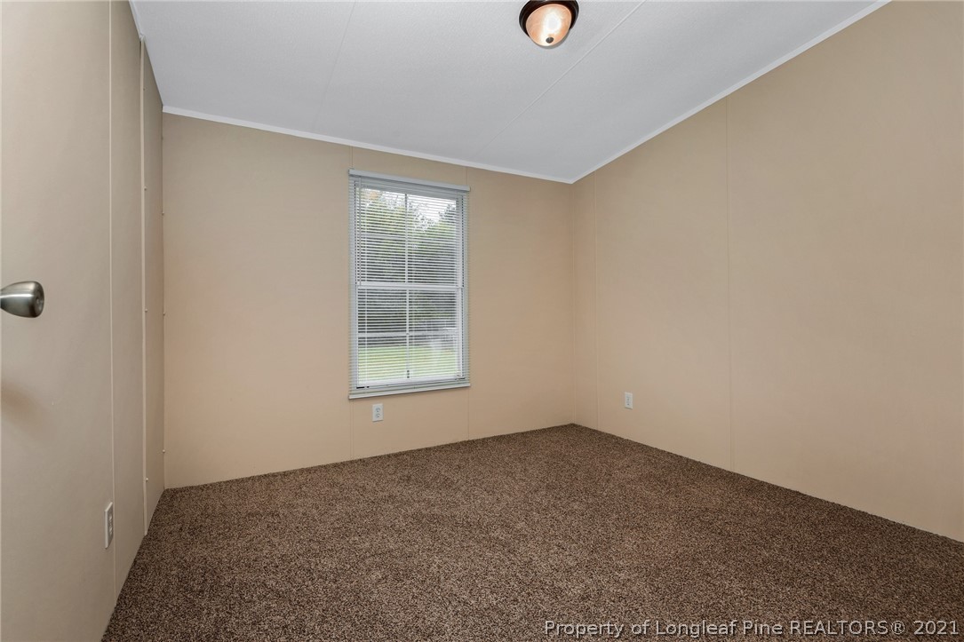 6544 Sandy Creek Road Stedman, NC 28391 - Photo 23 of 32 an empty room with a window