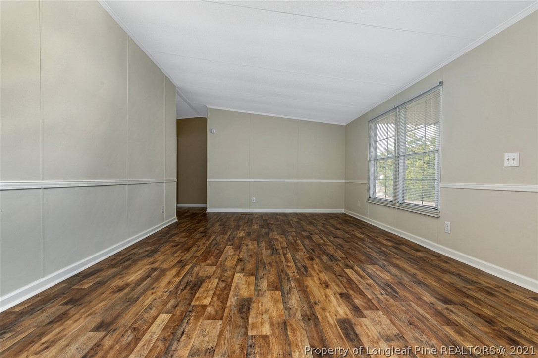 6544 Sandy Creek Road Stedman, NC 28391 - Photo 6 of 32 a view of empty room with wooden floor and fan