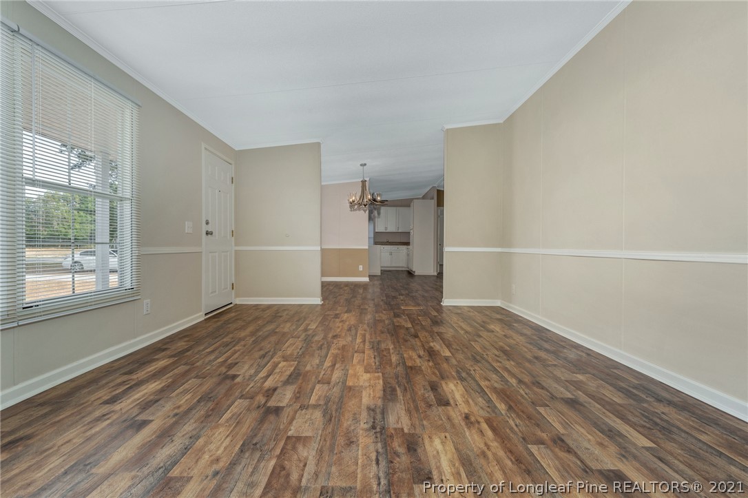 6544 Sandy Creek Road Stedman, NC 28391 - Photo 8 of 32 a view of empty room with wooden floor and windows