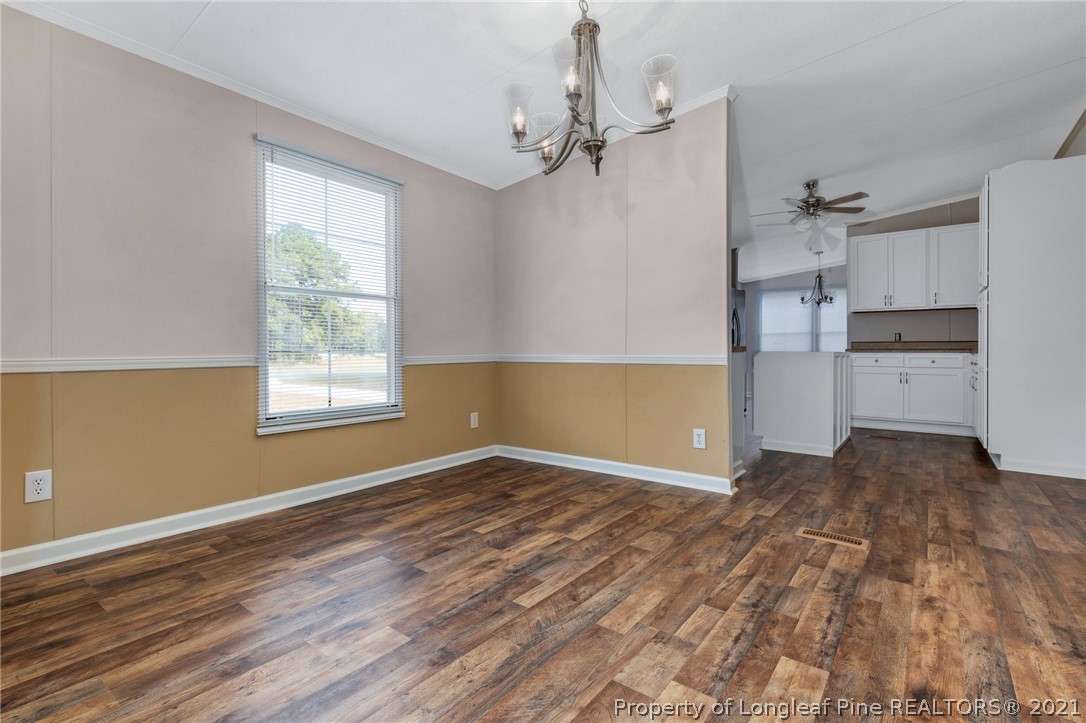 6544 Sandy Creek Road Stedman, NC 28391 - Photo 9 of 32 wooden floor in an empty room with a window