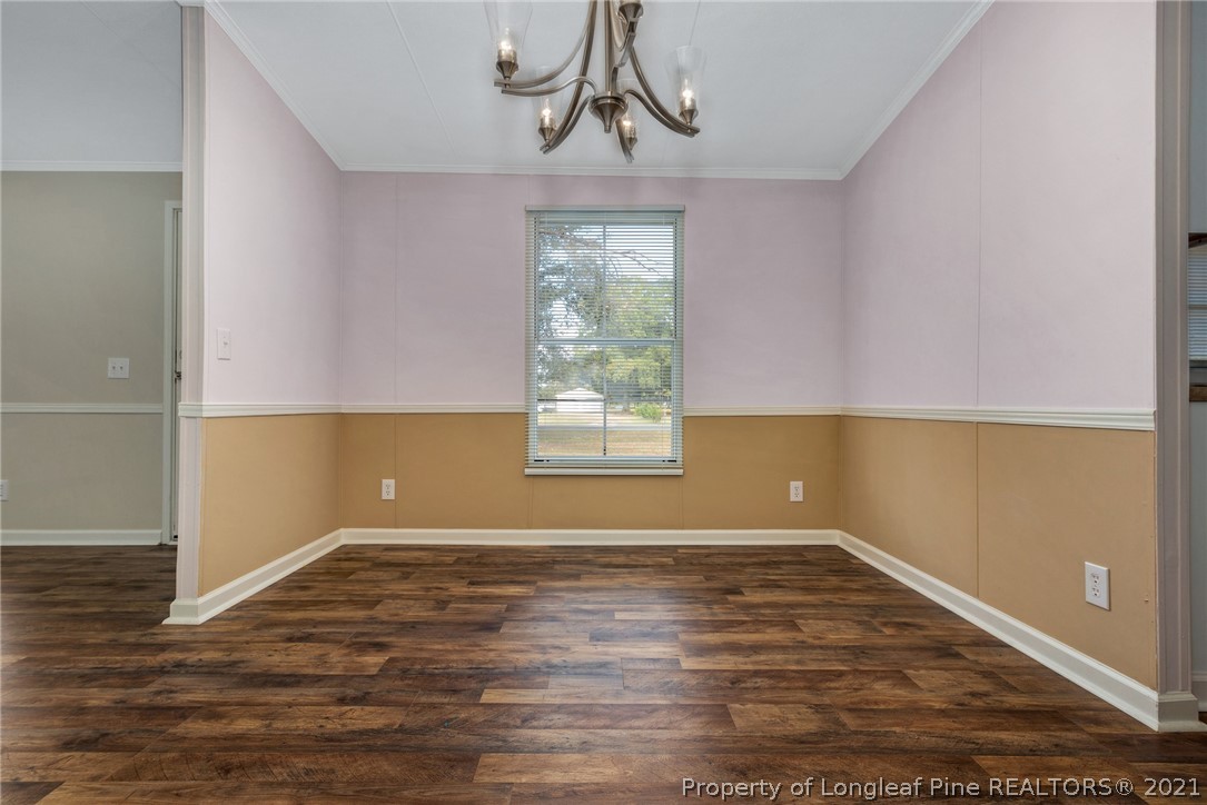 6544 Sandy Creek Road Stedman, NC 28391 - Photo 10 of 32 an empty room with wooden floor window and windows