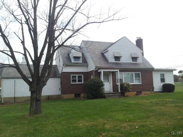 a view of house with a yard