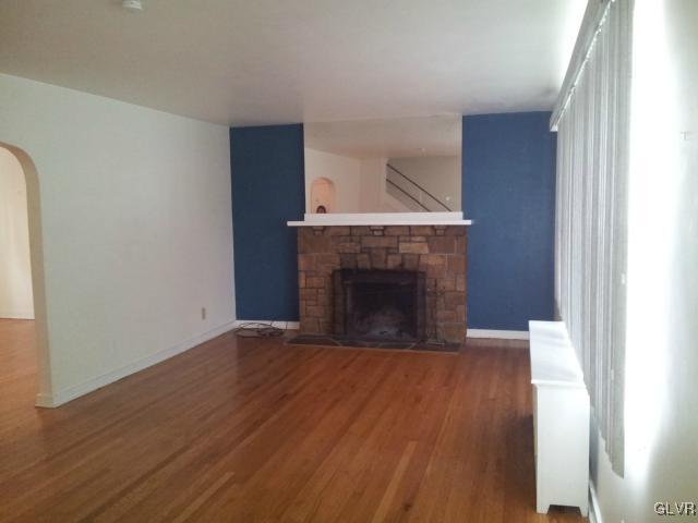 2110 Center Street Bethlehem, PA 18017 - Photo 7 of 12 a view of empty room with wooden floor and fireplace