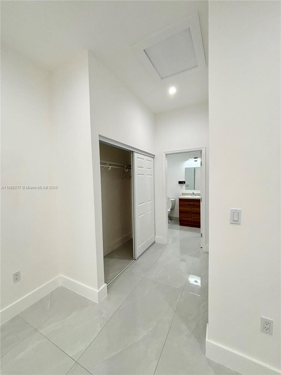 5737 Cleveland Street, Unit 2 Hollywood, FL 33021 - Photo 12 of 18 an empty room with kitchen and a sink