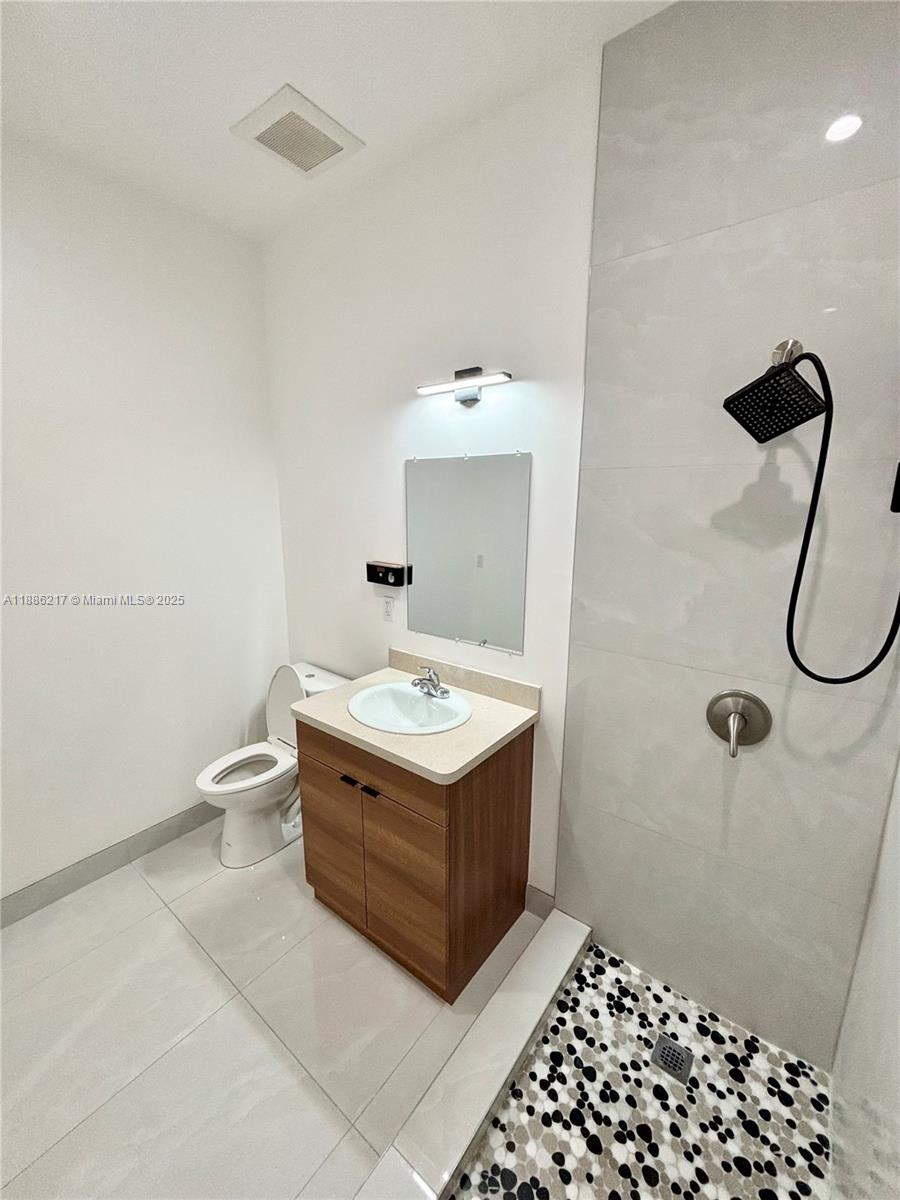 5737 Cleveland Street, Unit 2 Hollywood, FL 33021 - Photo 15 of 18 a bathroom with a sink a toilet and shower