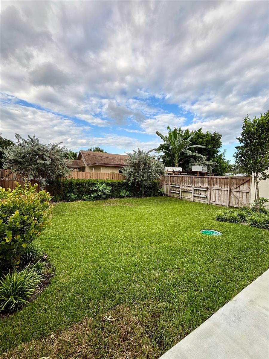 5737 Cleveland Street, Unit 2 Hollywood, FL 33021 - Photo 16 of 18 a view of yard with swimming pool and green space