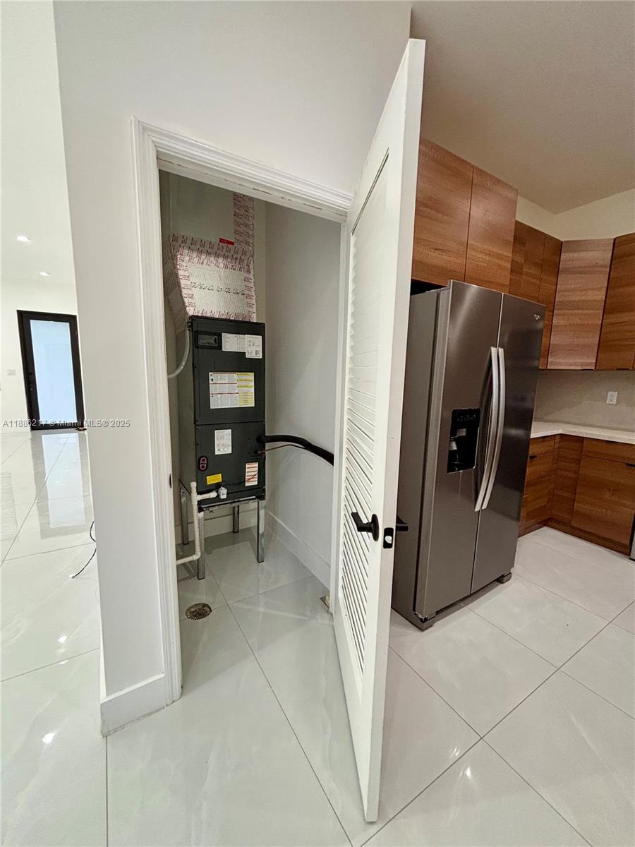 5737 Cleveland Street, Unit 2 Hollywood, FL 33021 - Photo 2 of 18 a view of a refrigerator and storage in a room