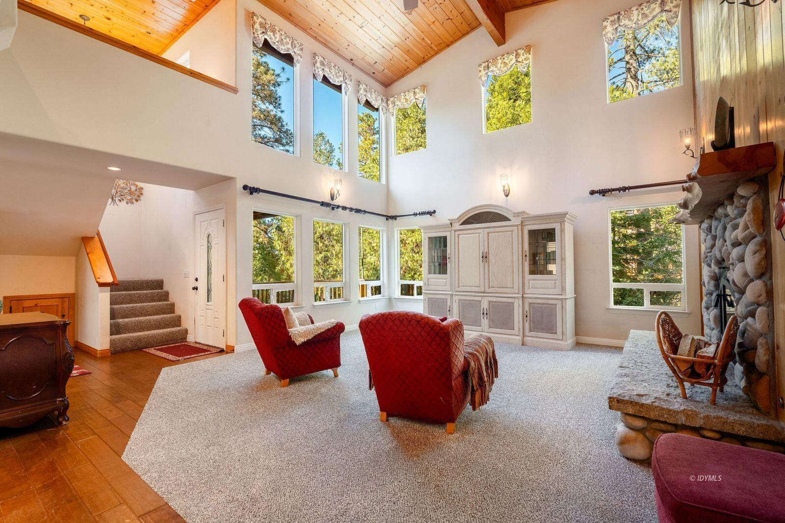25262 Deer Path Road Idyllwild, CA 92549 - Photo 11 of 45 a living room with furniture fireplace and a large window