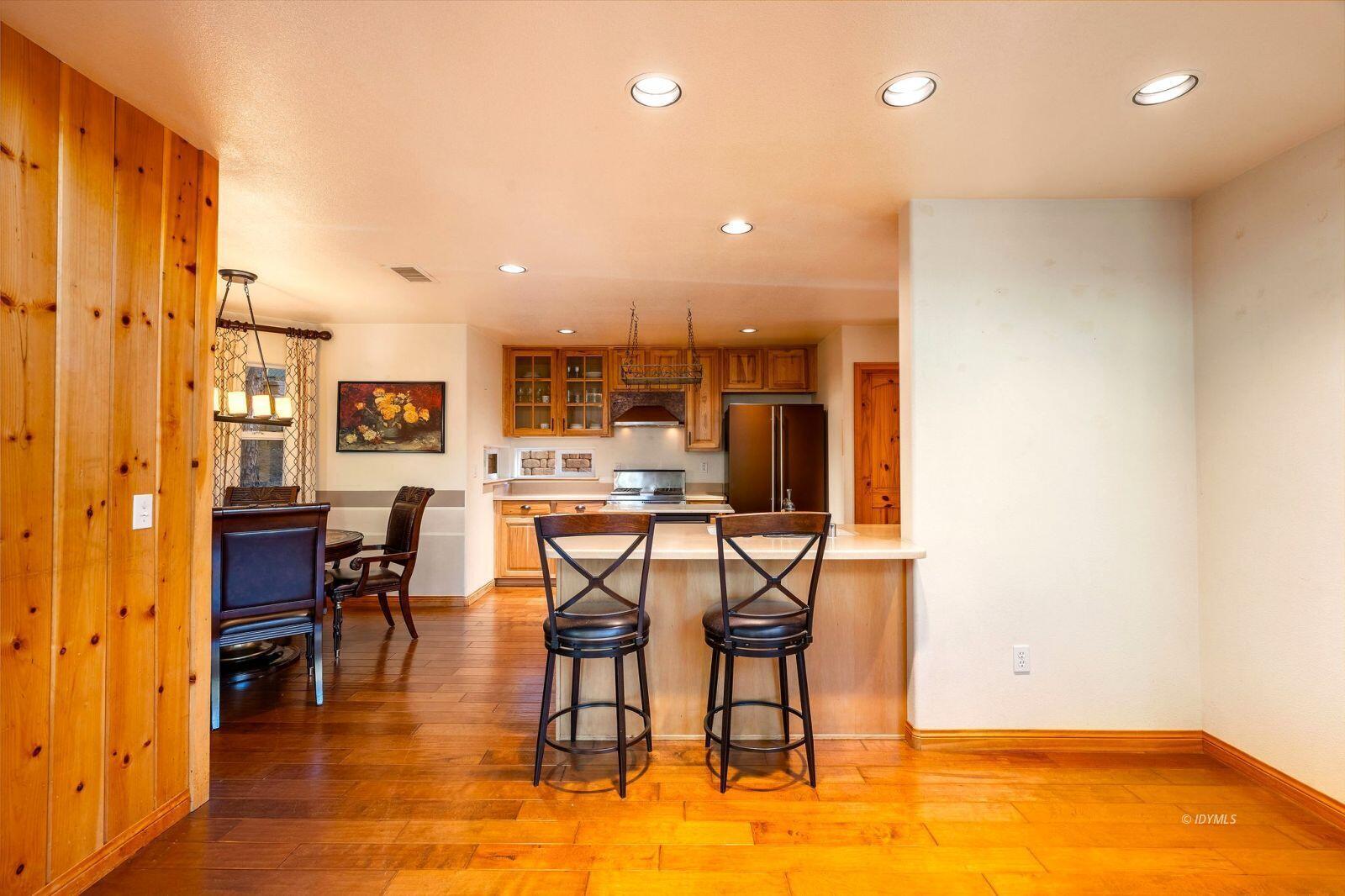 25262 Deer Path Road Idyllwild, CA 92549 - Photo 12 of 45 a dining room with stainless steel appliances a dining table chairs and kitchen view