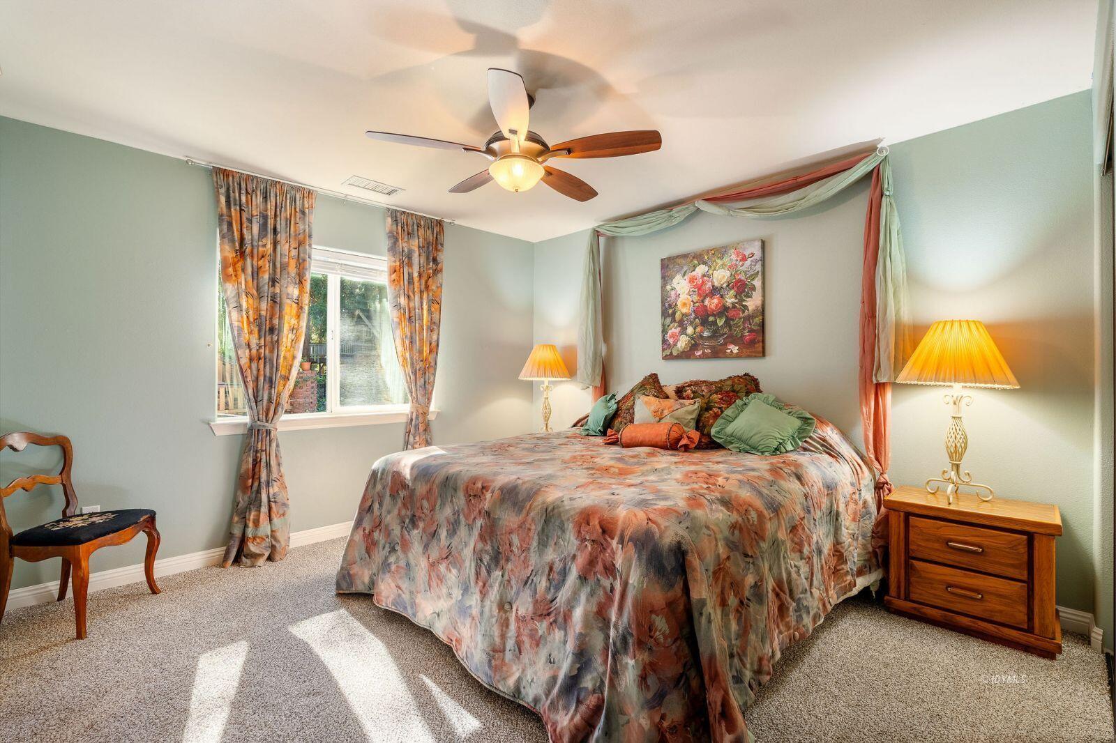 25262 Deer Path Road Idyllwild, CA 92549 - Photo 32 of 45 a bedroom with a bed and a chandelier