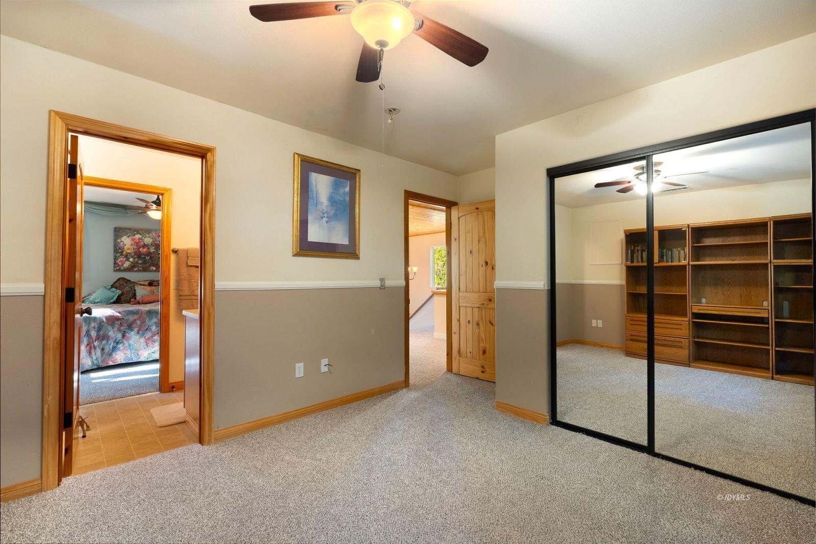 25262 Deer Path Road Idyllwild, CA 92549 - Photo 35 of 45 an empty room with closet and a chandelier fan