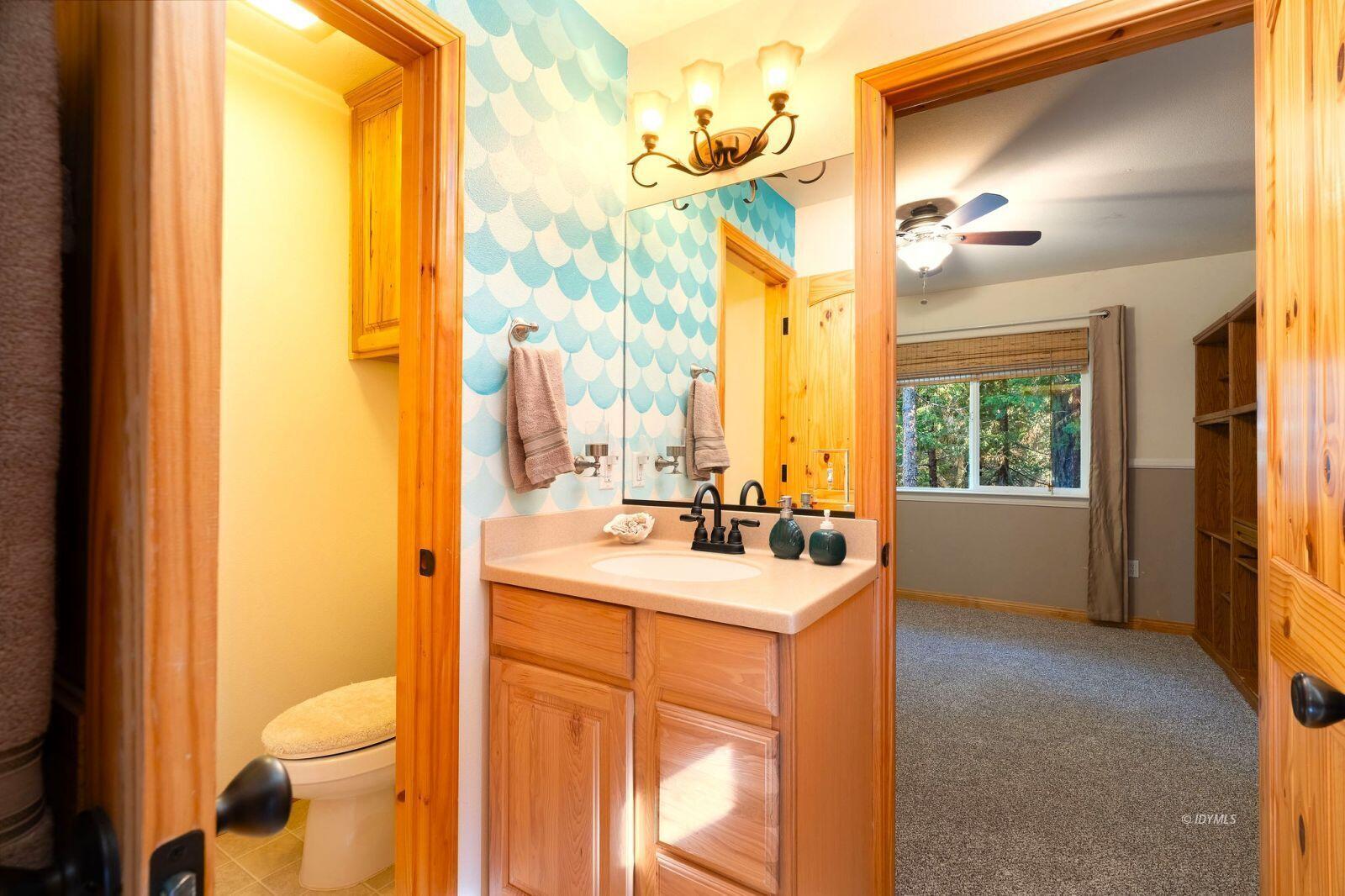 25262 Deer Path Road Idyllwild, CA 92549 - Photo 37 of 45 a bathroom with a sink a toilet and a mirror