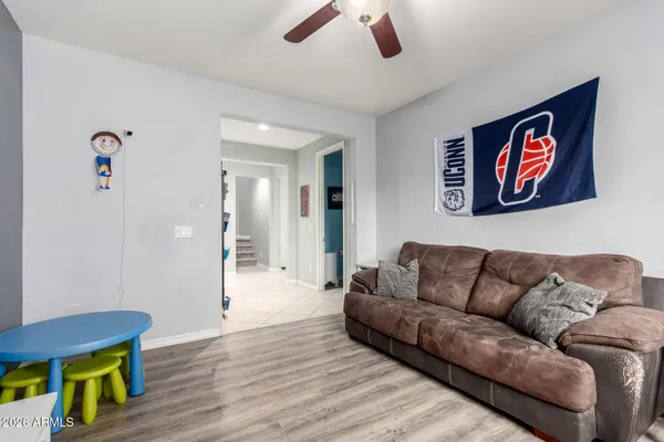 a living room with furniture and a wooden floor