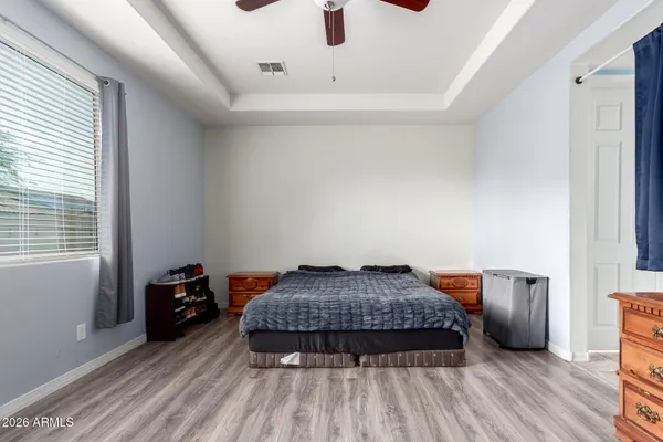 a bedroom with a bed and wooden floor