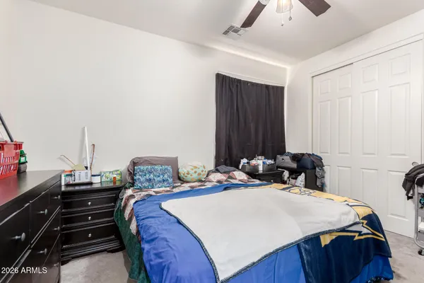 a bedroom with a bed and a closet