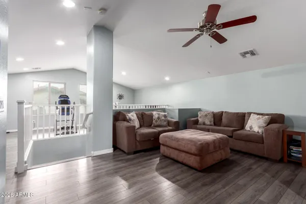 a living room with furniture and a wooden floor