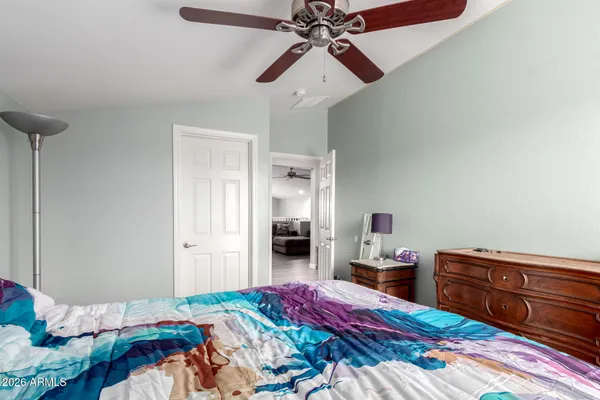 a bedroom with a bed and a chandelier