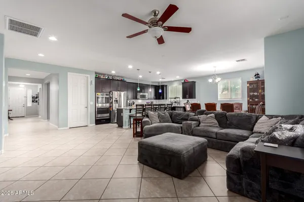 a living room with furniture and kitchen view