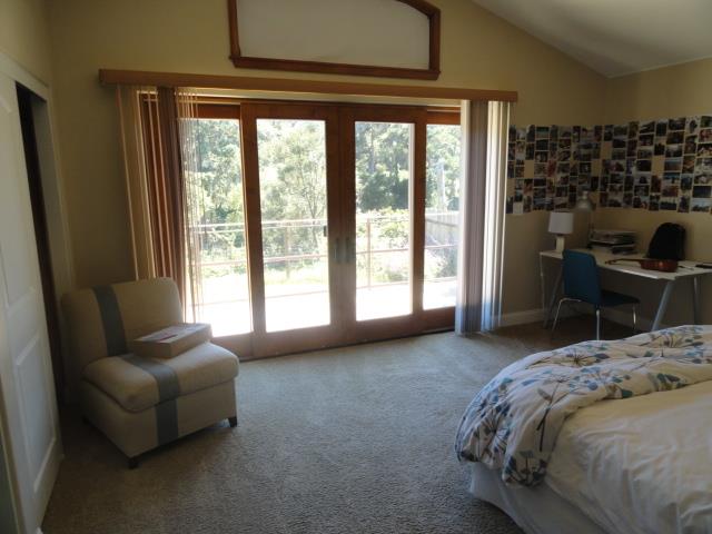 3165 Bird Rock Road Pebble Beach, CA 93953 - Photo 11 of 18 a bedroom with a bed and a couch next to a window