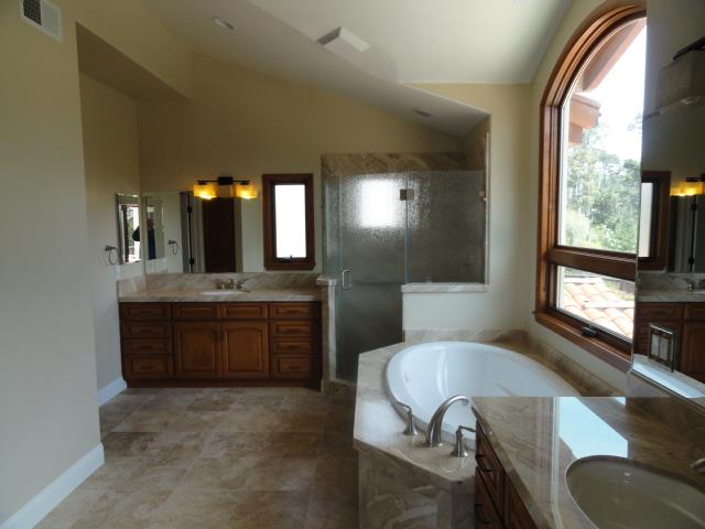 3165 Bird Rock Road Pebble Beach, CA 93953 - Photo 16 of 18 a spacious bathroom with a granite countertop sink a mirror and a bathtub