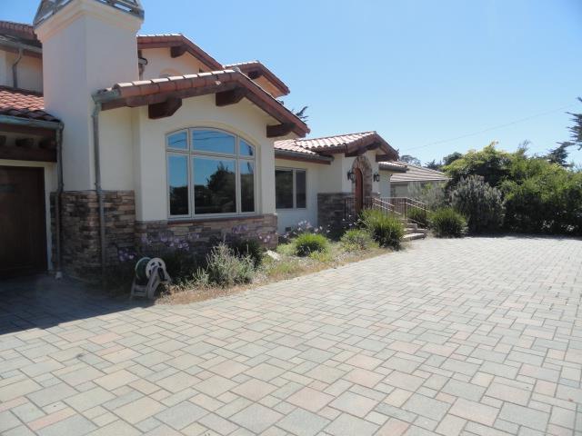 3165 Bird Rock Road Pebble Beach, CA 93953 - Photo 2 of 18 a front view of a house with a yard