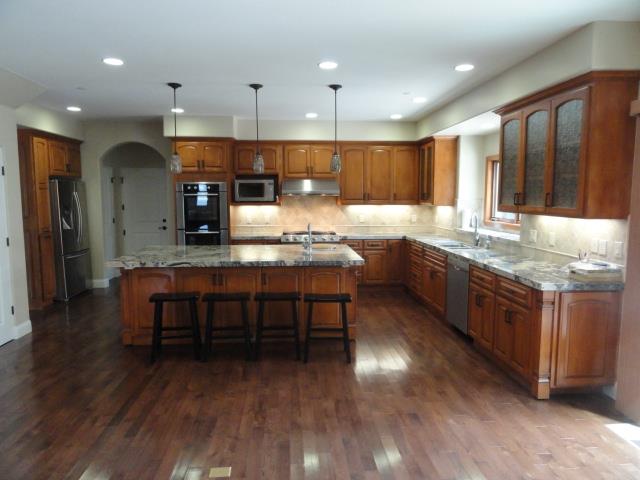 3165 Bird Rock Road Pebble Beach, CA 93953 - Photo 10 of 18 a large kitchen with a large island in the center a sink a counter space and stainless steel appliances