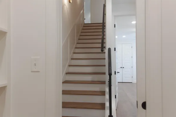 a bathroom with a toilet sink vanity and mirror