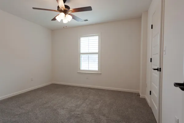 an empty room with a ceiling fan