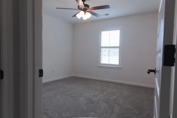 a view of an empty room with a fireplace