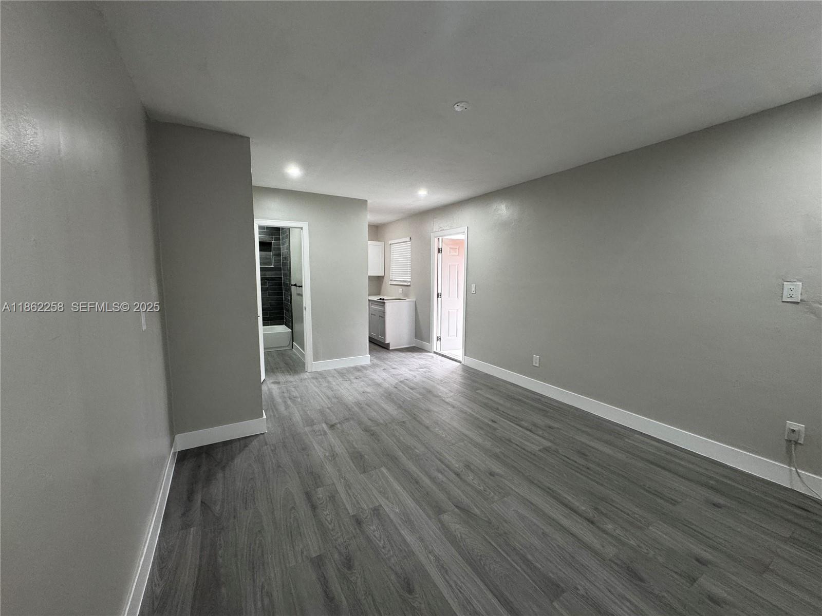 2377 Northwest 35th Street, Unit UTILITIES Miami, FL 33142 - Photo 8 of 9 a view of empty room with wooden floor