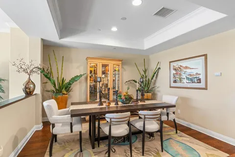 a dining room with furniture and wooden floor