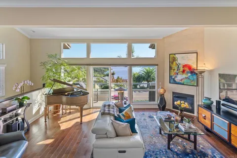 a living room with fireplace furniture and a large window