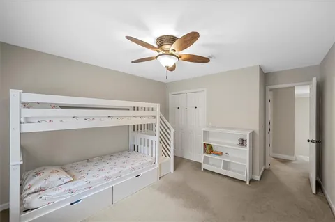 a bedroom with a bed and a ceiling fan