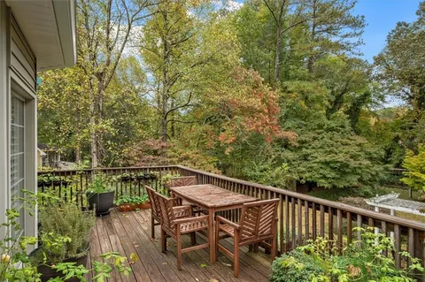 a view of a chairs and table on the balcony