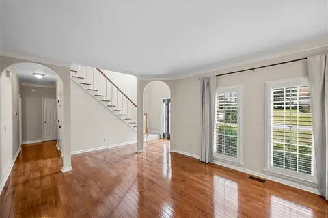 a view of entryway and hall with wooden floor