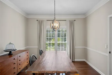a view of a room with wooden floor fan and windows