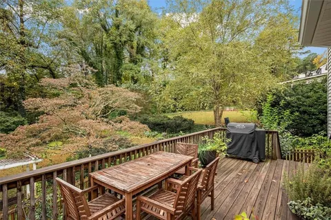 a view of balcony with wooden floor and fence