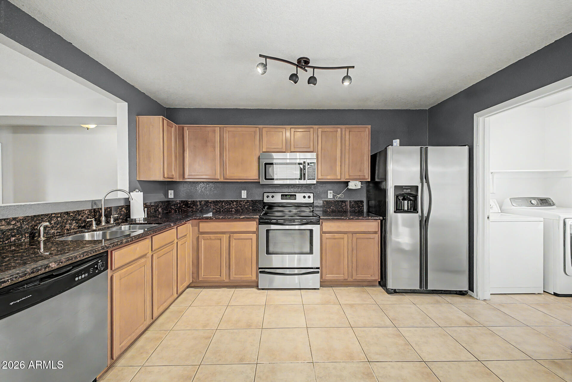 3489 South Bowman Road Apache Junction, AZ 85119 - Photo 15 of 24 a kitchen with a refrigerator sink and cabinets