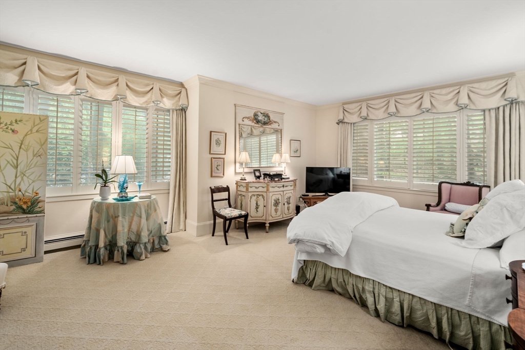 228 Allandale Road, Unit 1A Boston, MA 02467 - Photo 12 of 17 a bedroom with a bed and a large window