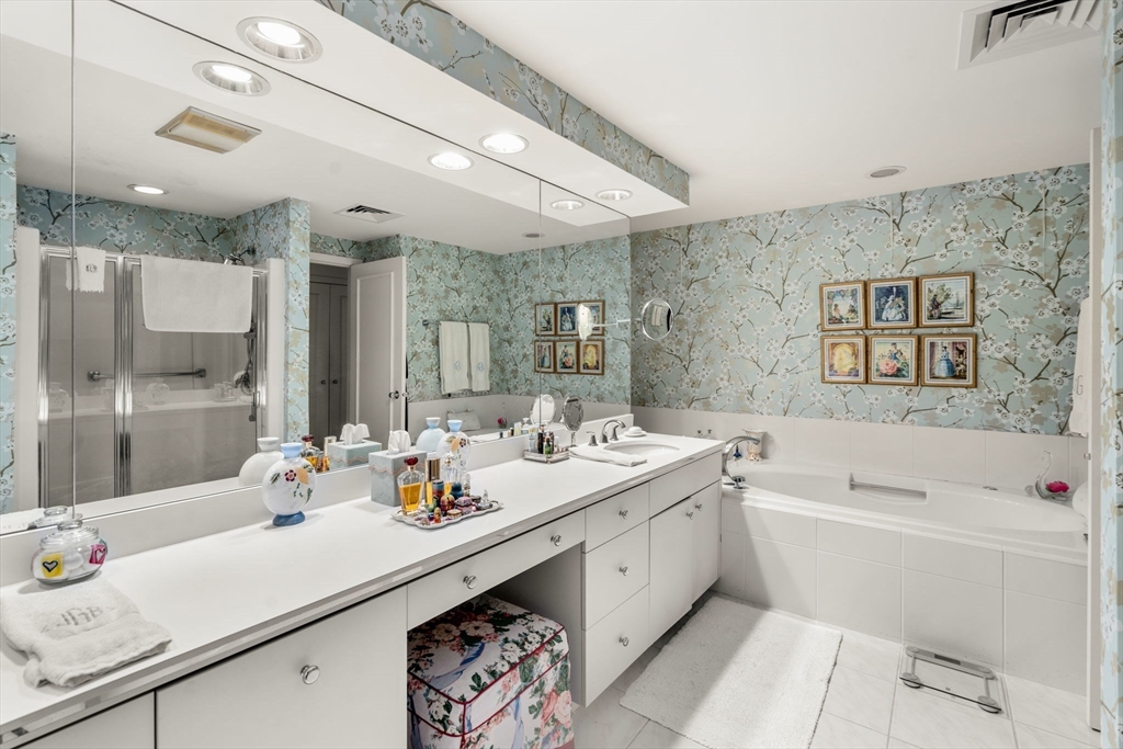 228 Allandale Road, Unit 1A Boston, MA 02467 - Photo 14 of 17 a bathroom with a double vanity sink mirror and bathtub