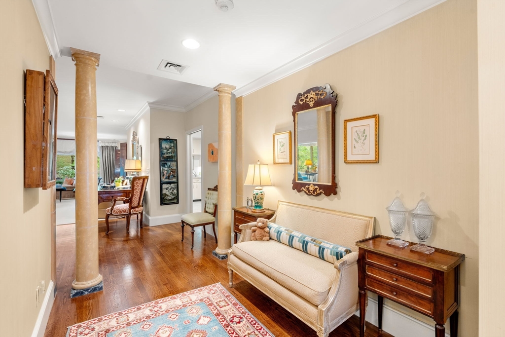 228 Allandale Road, Unit 1A Boston, MA 02467 - Photo 2 of 17 a living room with furniture and a wooden floor