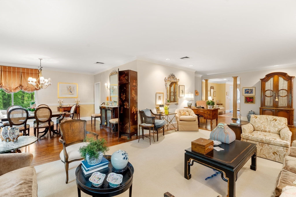 228 Allandale Road, Unit 1A Boston, MA 02467 - Photo 6 of 17 a living room with furniture kitchen and a chandelier