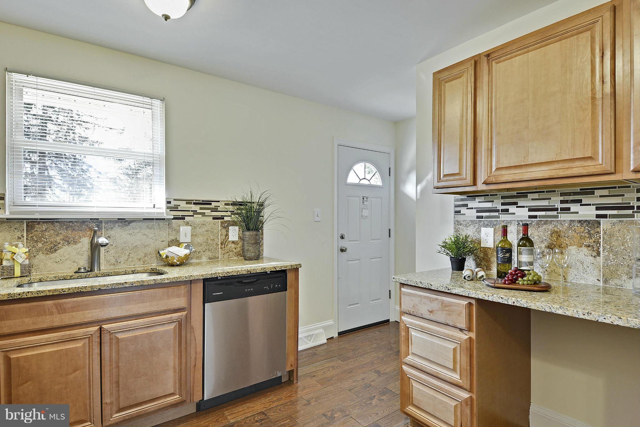 106 Harmony Hall Road Gaithersburg, MD 20877 - Photo 12 of 30 a kitchen with stainless steel appliances granite countertop a sink and a window