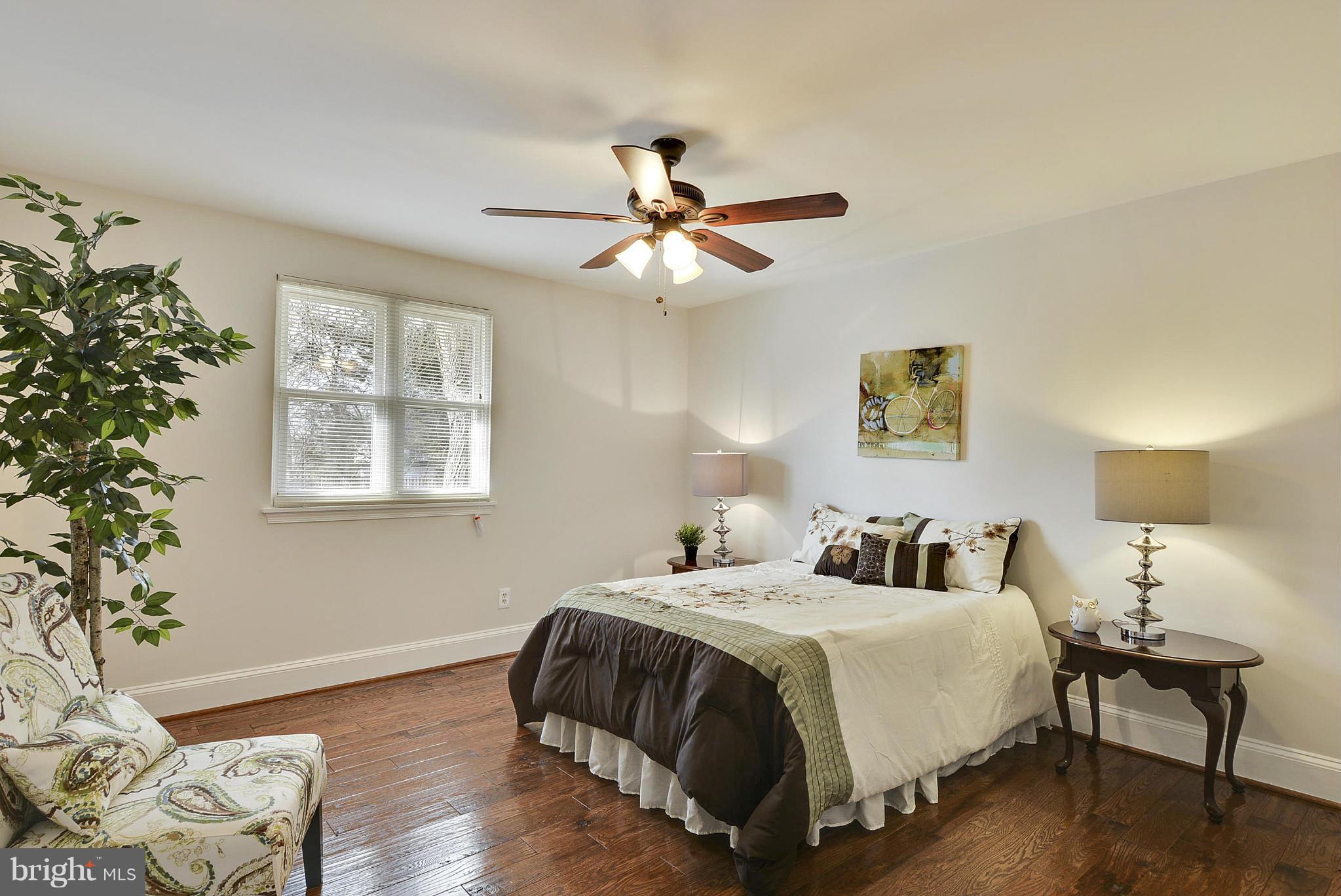 106 Harmony Hall Road Gaithersburg, MD 20877 - Photo 13 of 30 a bedroom with bed and a potted plant