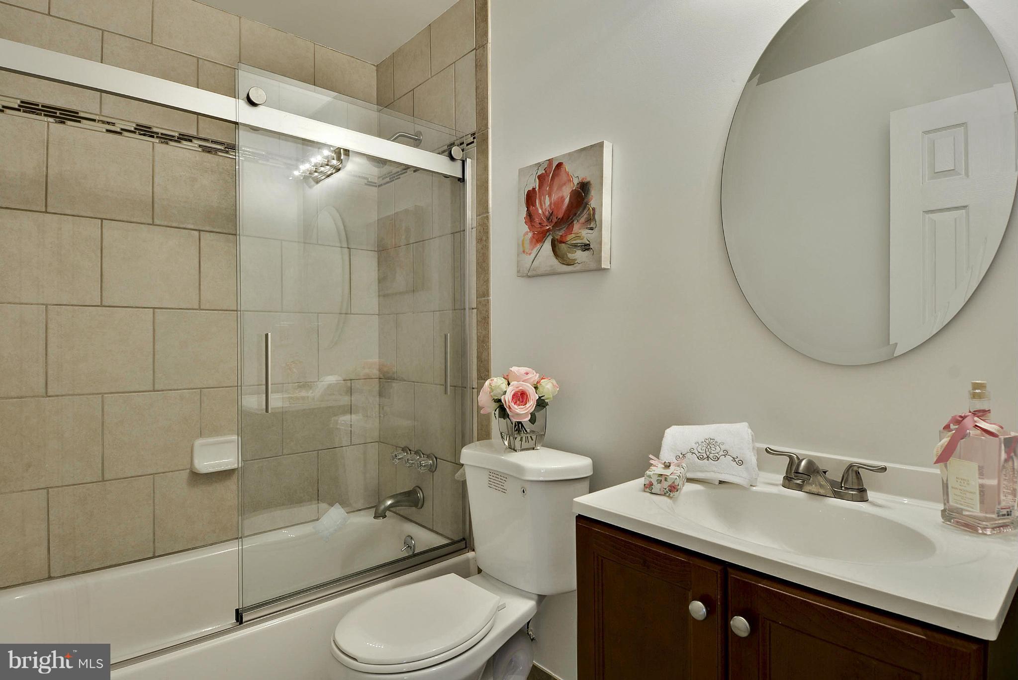 106 Harmony Hall Road Gaithersburg, MD 20877 - Photo 17 of 30 a bathroom with a sink toilet and shower