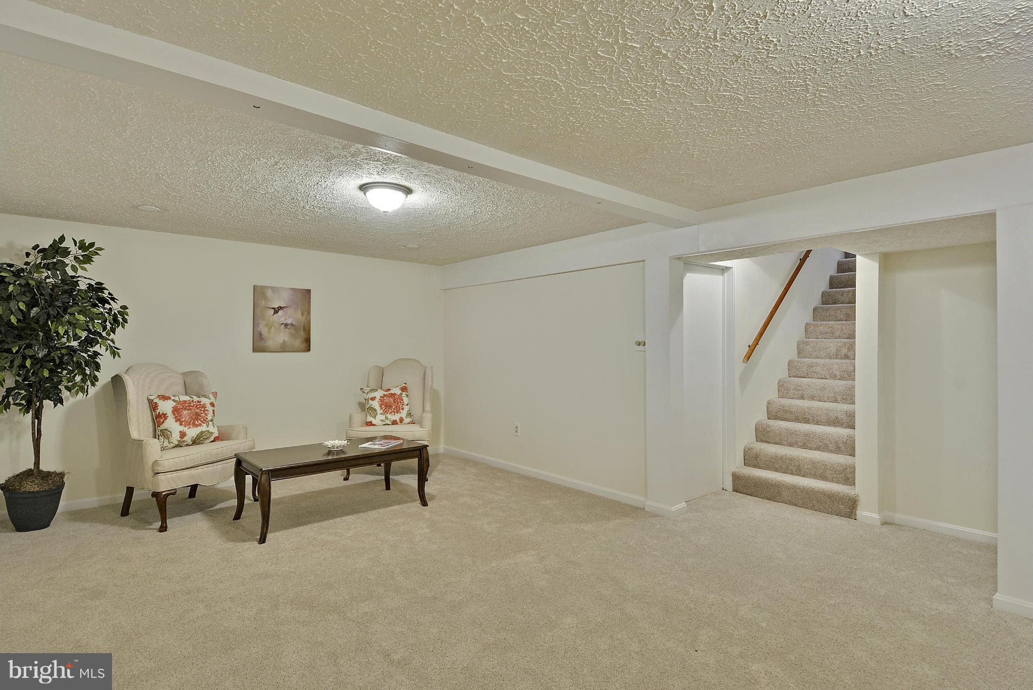 106 Harmony Hall Road Gaithersburg, MD 20877 - Photo 18 of 30 a view of an empty room with stairs and white walls