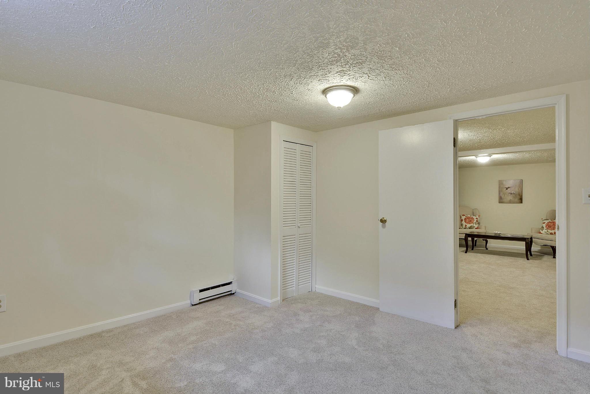 106 Harmony Hall Road Gaithersburg, MD 20877 - Photo 19 of 30 an empty room with mirror and a bench